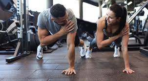 Toning Bingo Wings: Your Ultimate Guide to Sculpting Sleek Arms at the Gym 3 Fitness trainer demonstrating arm toning exercises Cambridgeshire