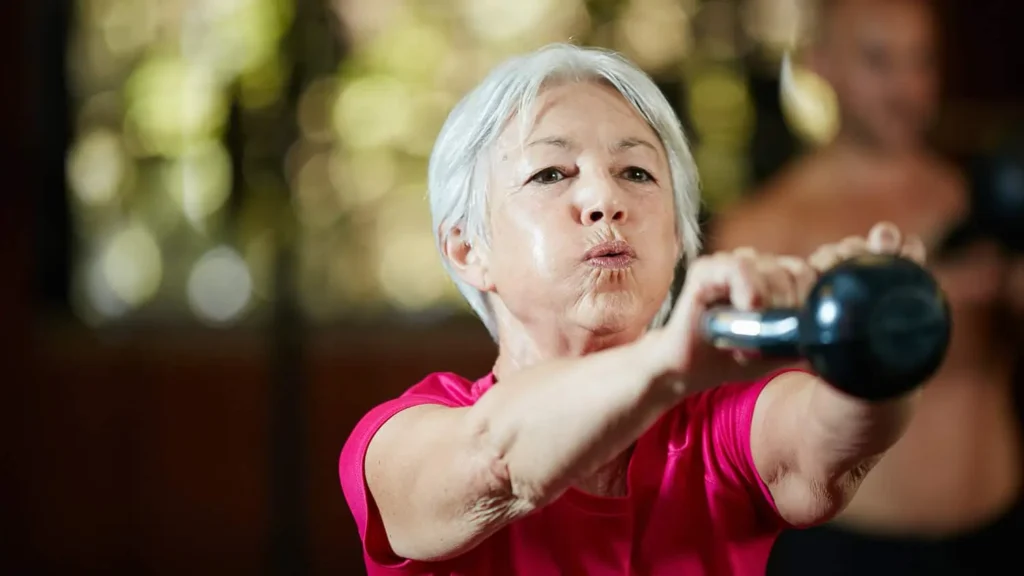 Toning Arms Without the Bulk: Is It Achievable? 1 Woman doing resistance band exercises for toned arms Cambridgeshire