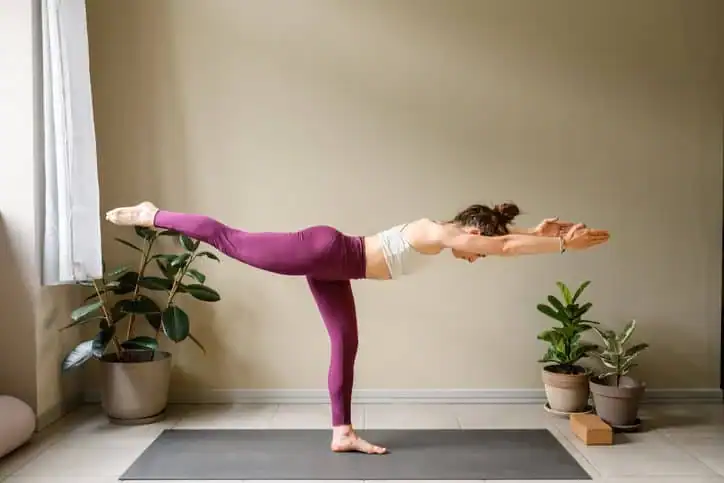 Woman doing Yoga exercise Cambridgeshire to help with toning the body. 